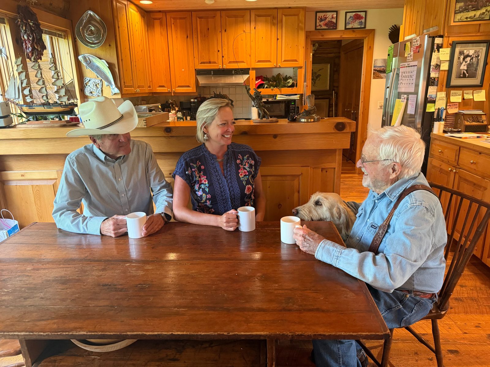 Rebecca Bextel visiting with Wyoming neighbors around a kitchen table